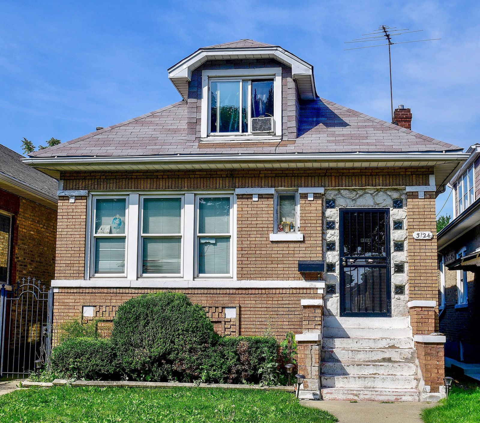 Brick Chicago bungalow with a new hip roof and dormer